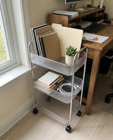 Rolling storage cart beside a desk in a home office